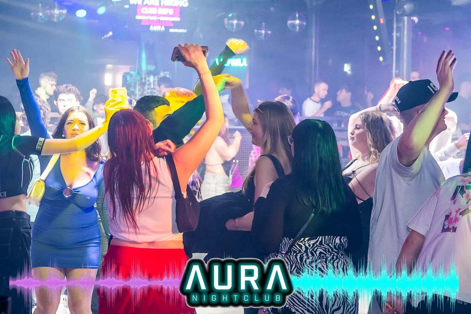 Guests dancing with hands up on the dancefloor